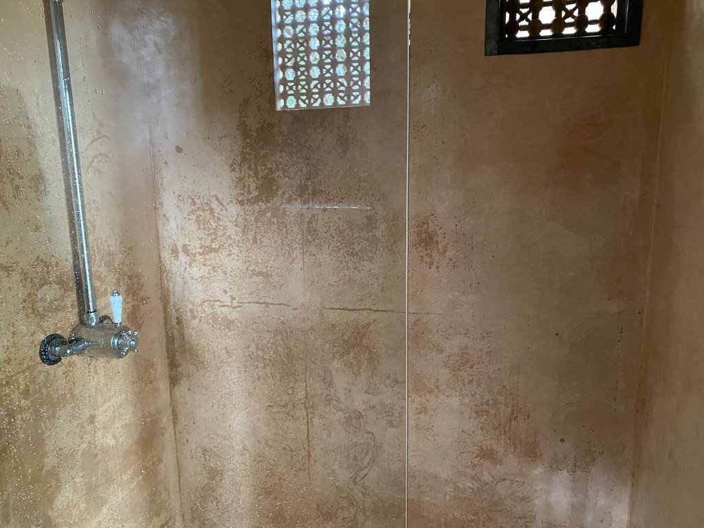 Tadelakt shower enclosure showing waterproof polished lime surface